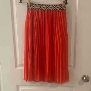 Elegant Red Pleated Skirt with Patterned Waistband